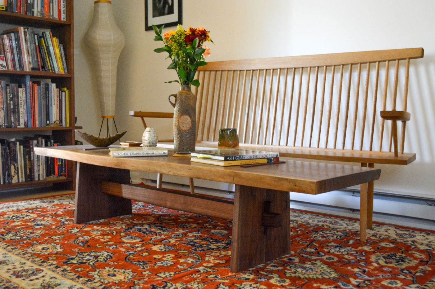 Rectangular live-edge coffee table on solid panel legs joined by a through-stretcher
