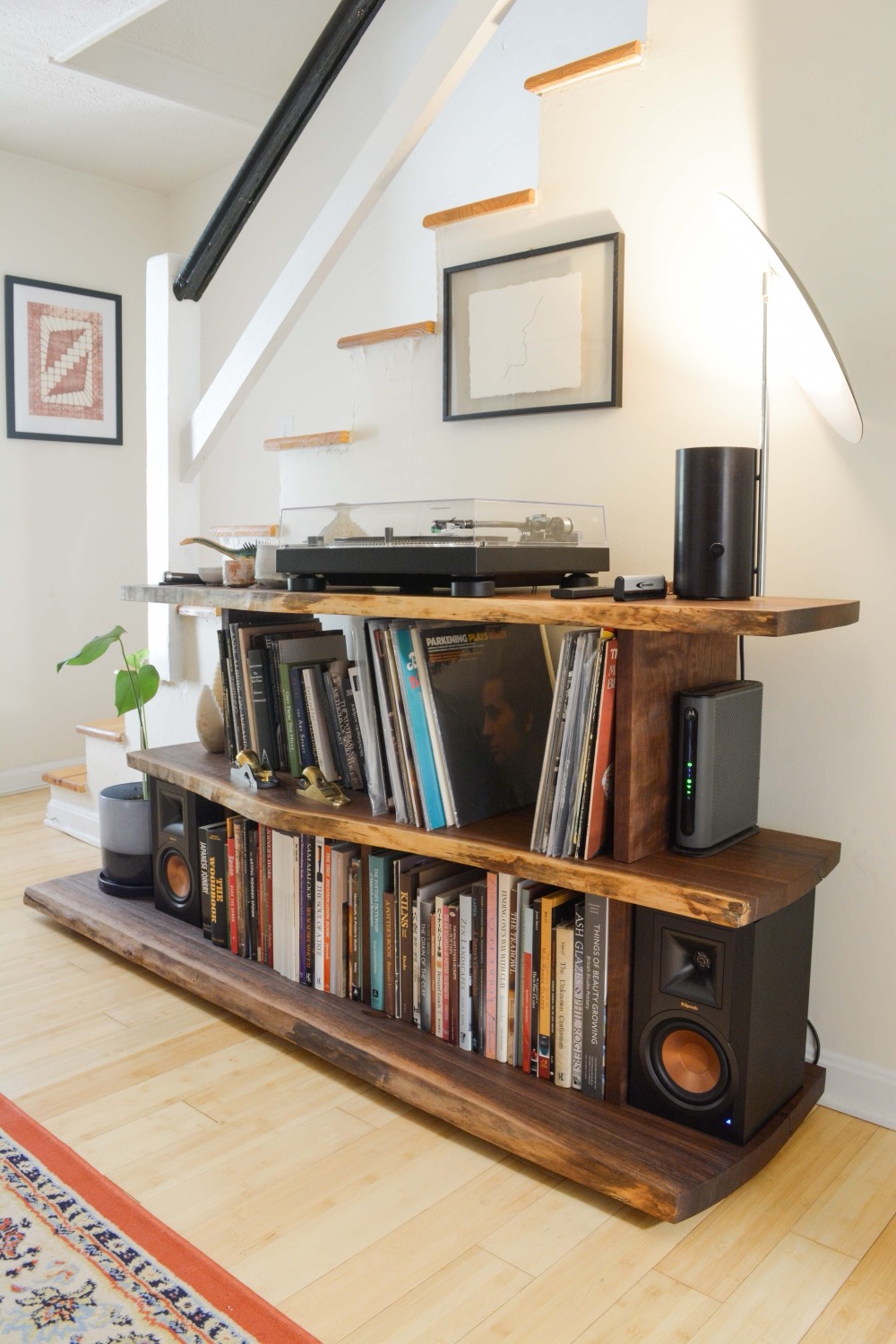 A live-edge record console with stacked open shelves